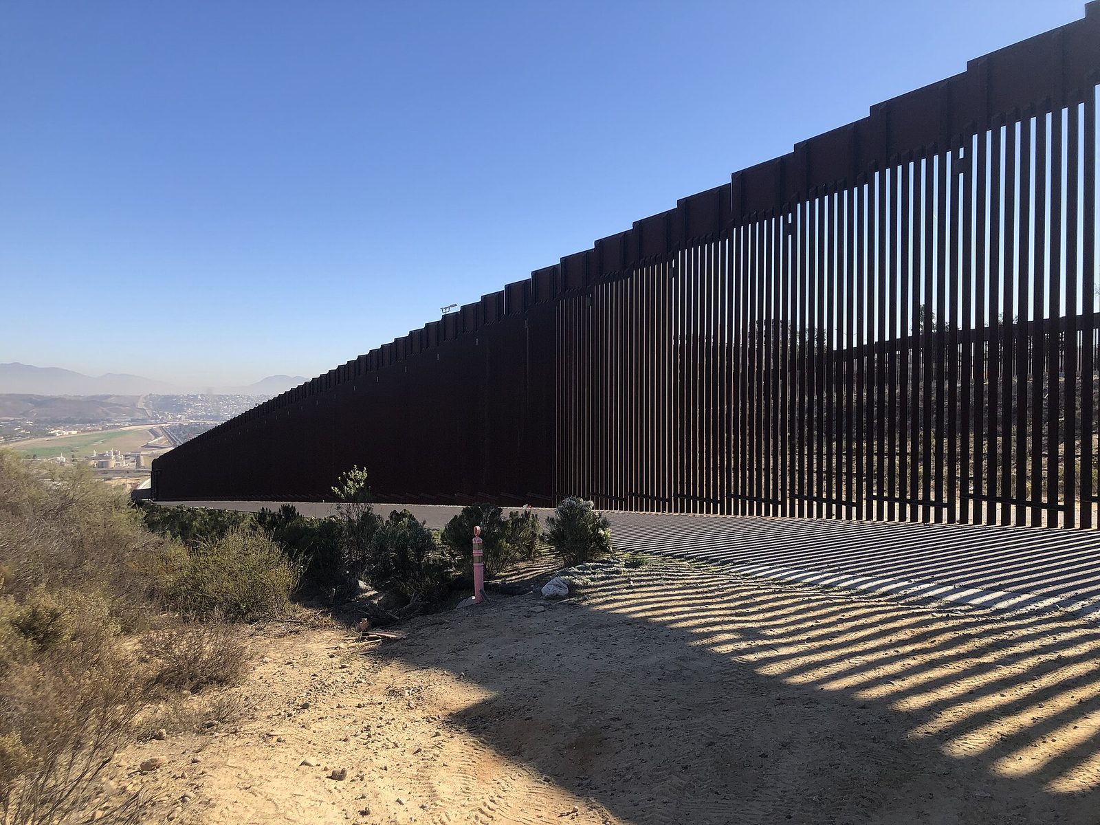 The border wall with Tijuana in the distance. About 136,000 people cross the California-Baja California border legally on a typical day, according to SANDAG's 2024 border data.