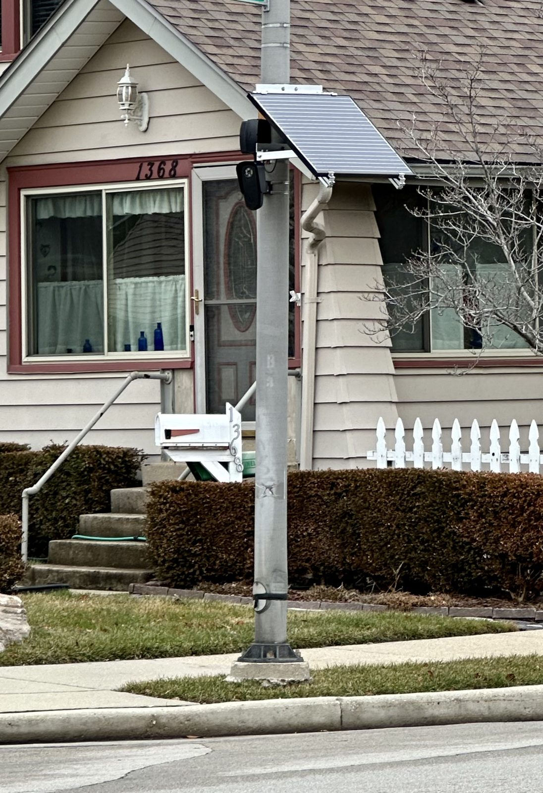 A Flock Safety automated license plate reader camera mounted on a pole. The lawsuit asks the city to uninstall its Flock and other license-plate cameras and delete all collected data.
