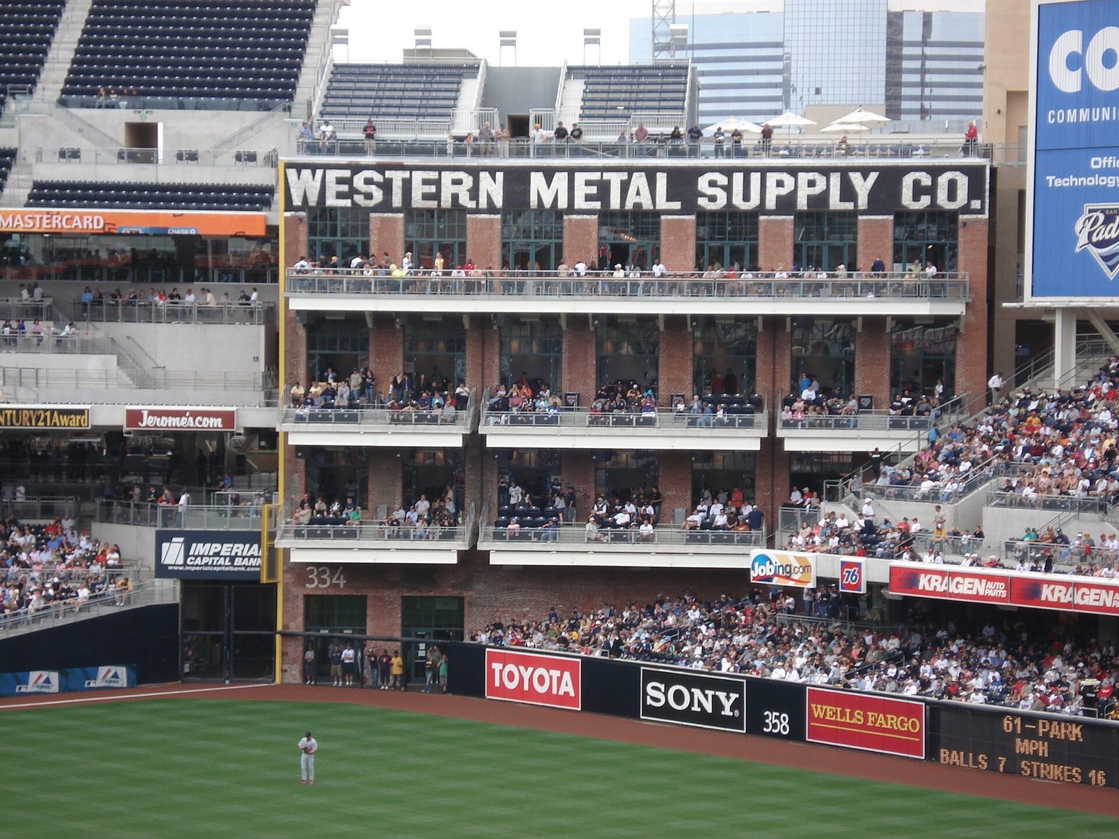 The Western Metal Supply Co. building at Petco Park, its upper-floor windows full of fans. Milwaukee has not won a postseason road game since 2018; Tuesday's loss was its twelfth straight.