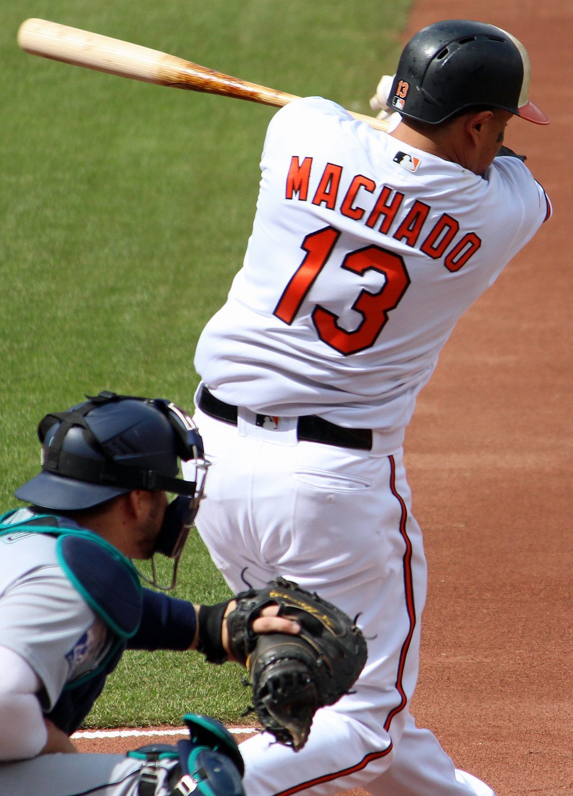 Manny Machado batting in his Baltimore Orioles days, "MACHADO 13" on his back. His 406-foot drive to center field in the eighth inning Wednesday was caught by Garrett Mitchell at the Petco Park wall.