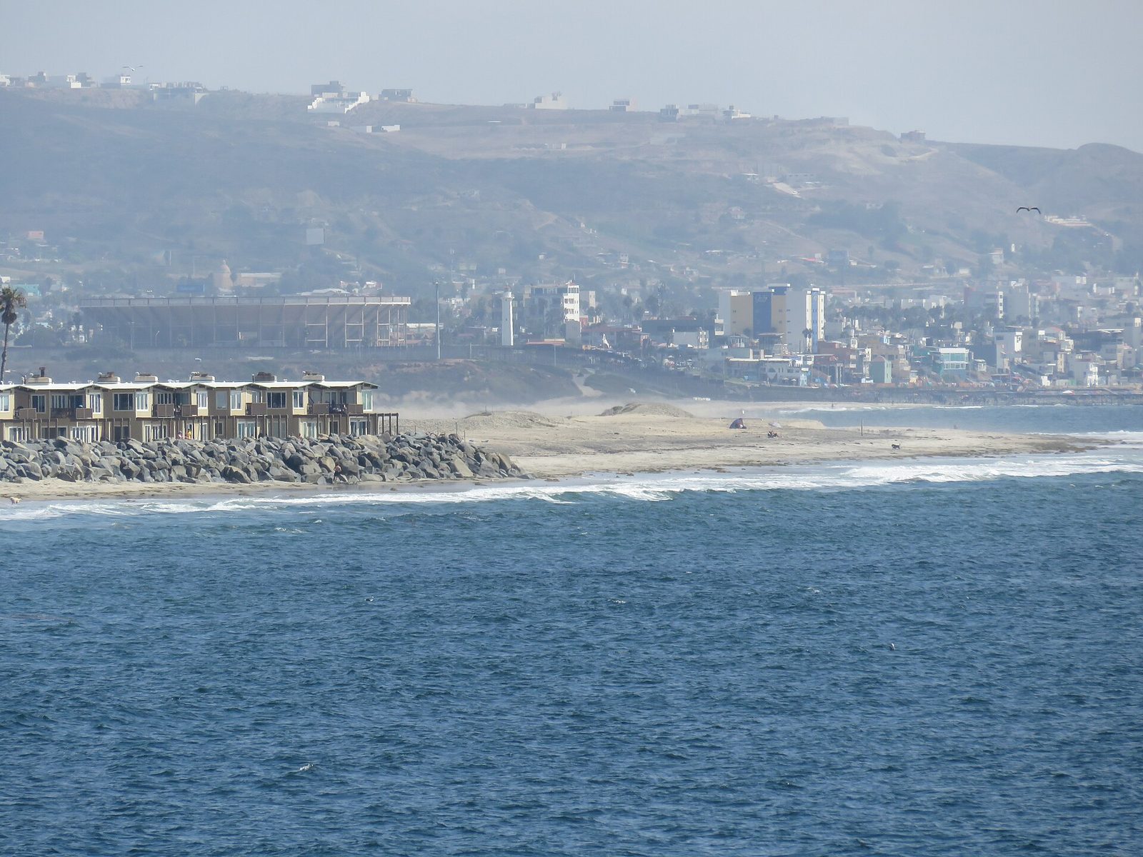 South from Imperial Beach Pier, the shoreline runs toward Tijuana and the Playas bullring at the border. Beach water quality along this stretch is monitored by the county's environmental health department, one of the six county teams the new chief will coordinate.
