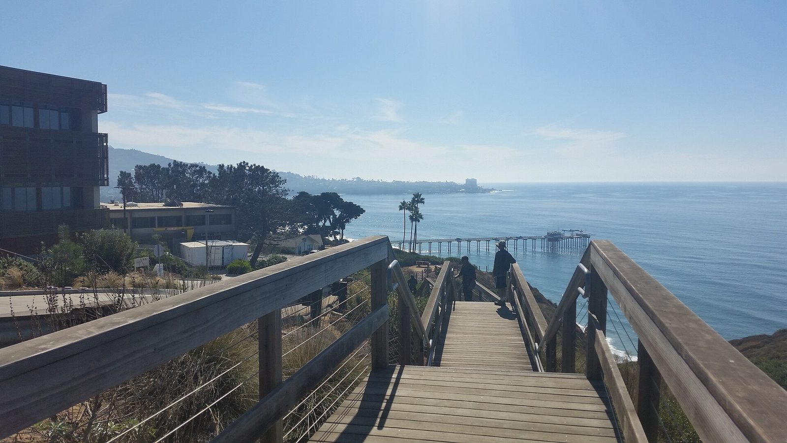 The stairs down to Scripps Pier from the institution's La Jolla campus. In September, the pier's tide gauge logged its highest monthly average sea level on record, a baseline the briefing says sets up a damaging winter if storms arrive on the highest tides.