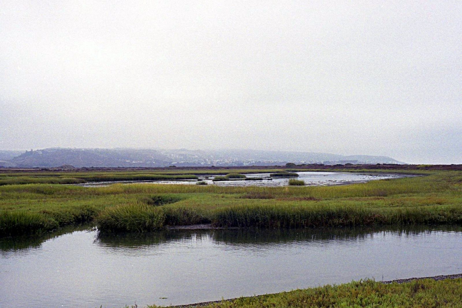 The Tijuana River estuary from above. The river drains a binational watershed; when Tijuana's infrastructure is overwhelmed, the flow reaches San Diego's shoreline.