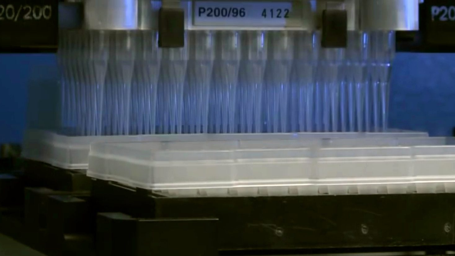 An automated liquid-handling workstation in a National Institute of Allergy and Infectious Diseases laboratory. NIAID, the NIH institute that funds the HIV trial networks, restructured them in 2020 with seven-year awards.