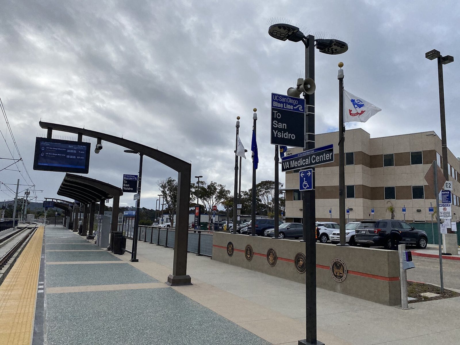 The VA Medical Center trolley station on the UC San Diego Blue Line, its platform wall carrying the seals of the armed services. The station puts the La Jolla campus on the trolley map for the veterans of San Diego and Imperial counties the system serves.