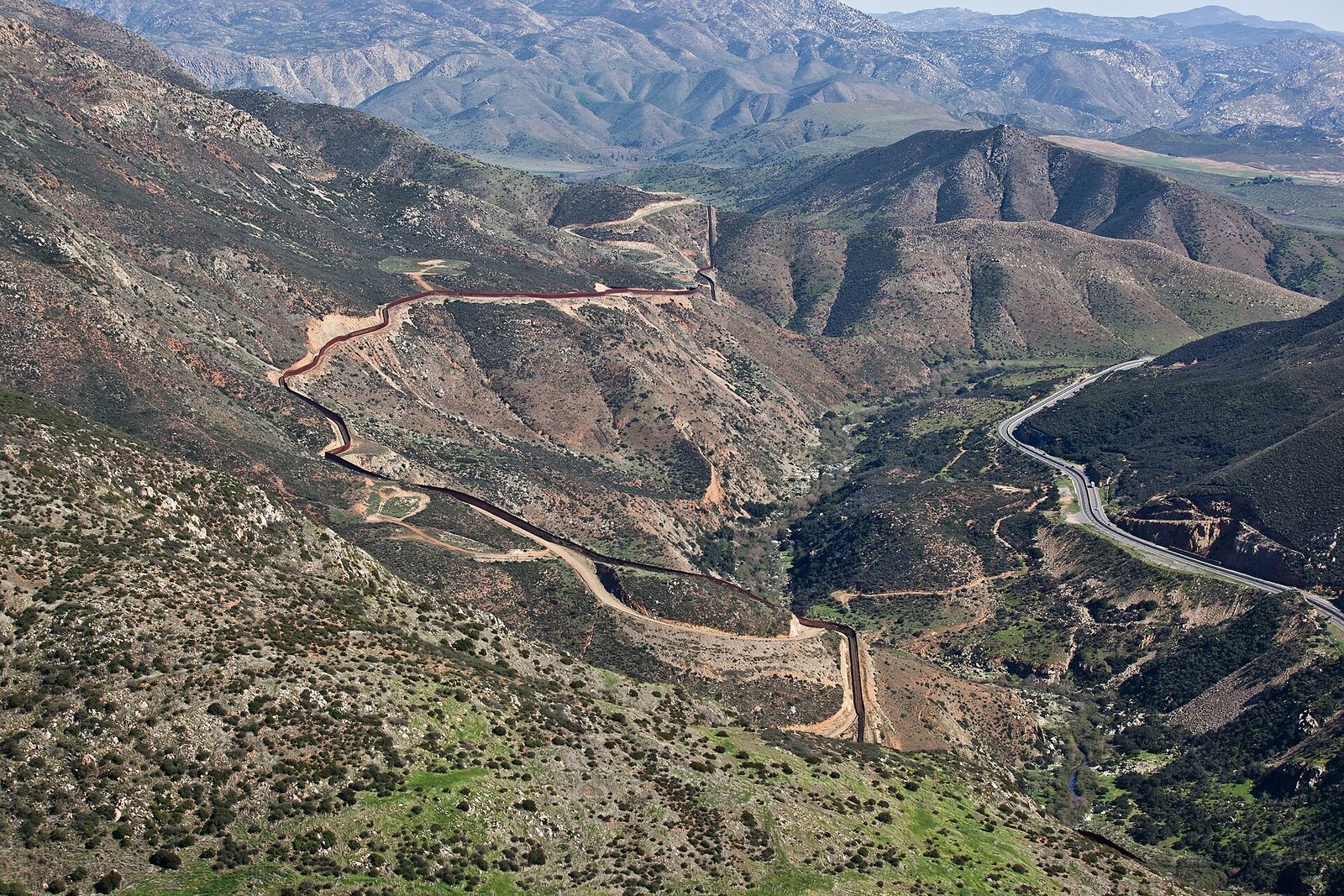 The border barrier east of San Diego, seen from the air. The Otay Mesa East port of entry is rising in the mesa country east of here.