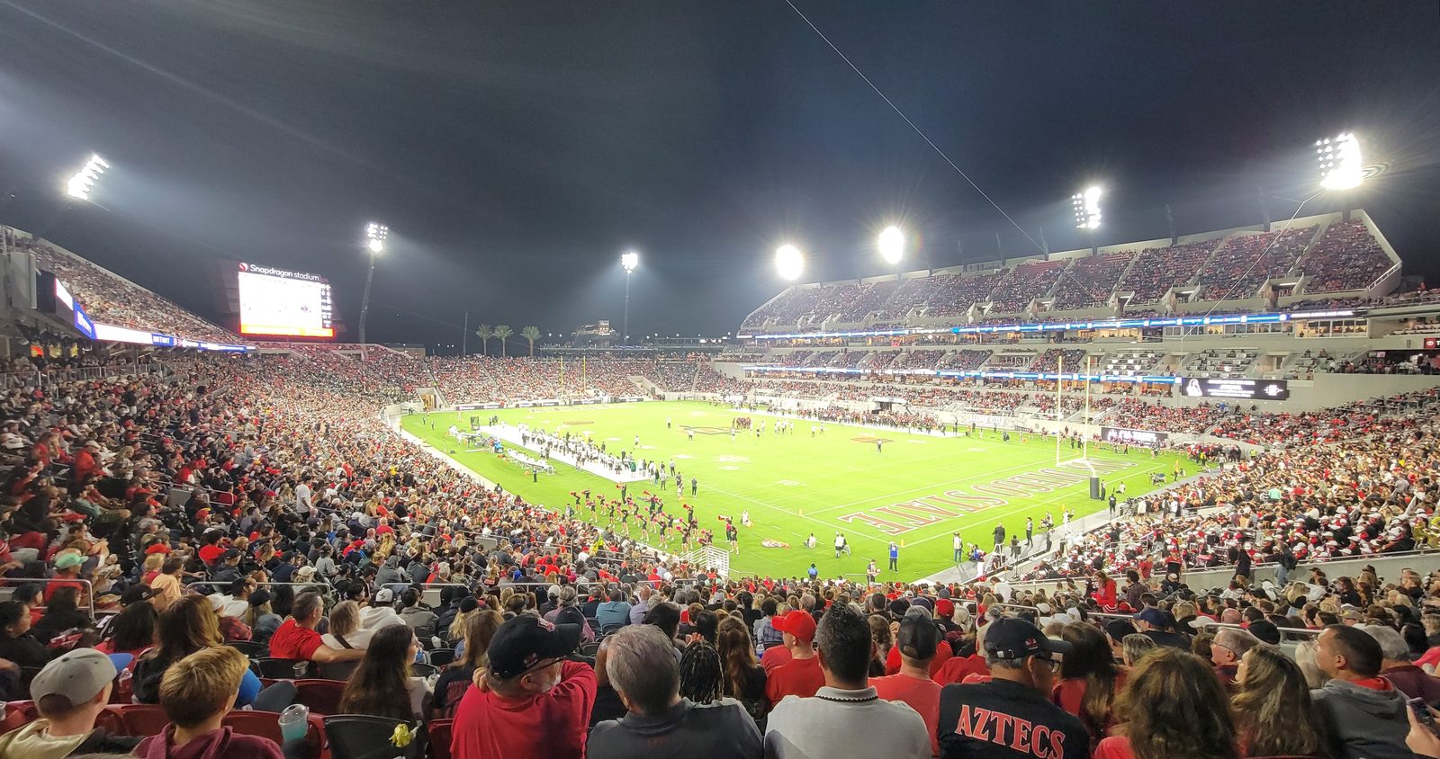 Snapdragon Stadium under the lights on a football night, with the Snapdragon Stadium signage lit above the bowl. San Diego FC hosted Houston here on Wednesday night in a league match that swung from 2-0 to 2-3 to 3-3.